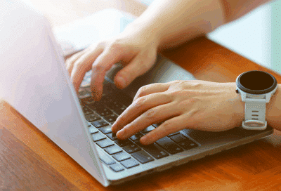 Closeup of a person working on a laptop, representing hentscher-johnson orthodontics new website