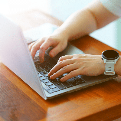 Closeup of a person working on a laptop, representing hentscher-johnson orthodontics new website