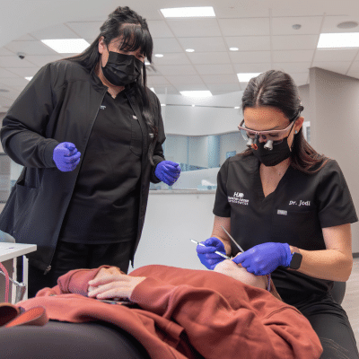Dr. Jodi working on a patient's teeth, representing how orthodontic movement works