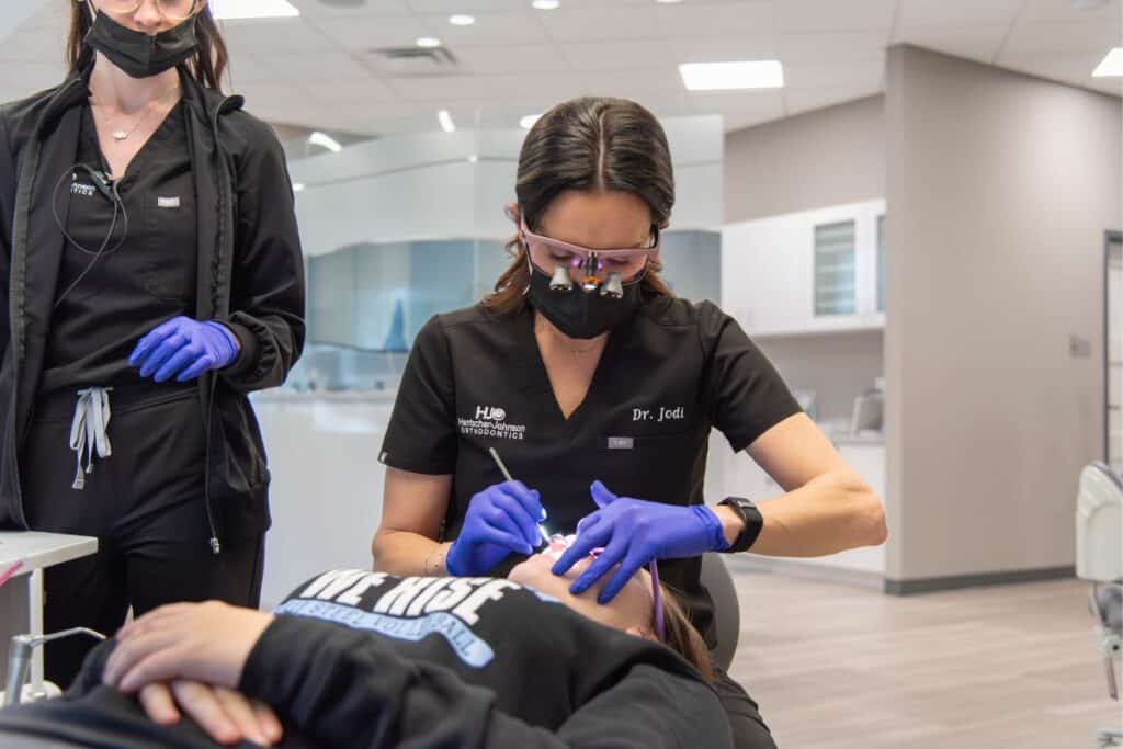 Dr. Jodi working on a patient’s teeth at a top-rated orthodontic practice.